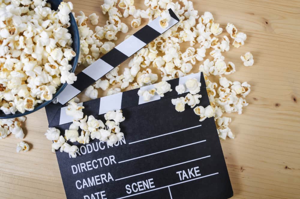 Movie clapper board with popcorn