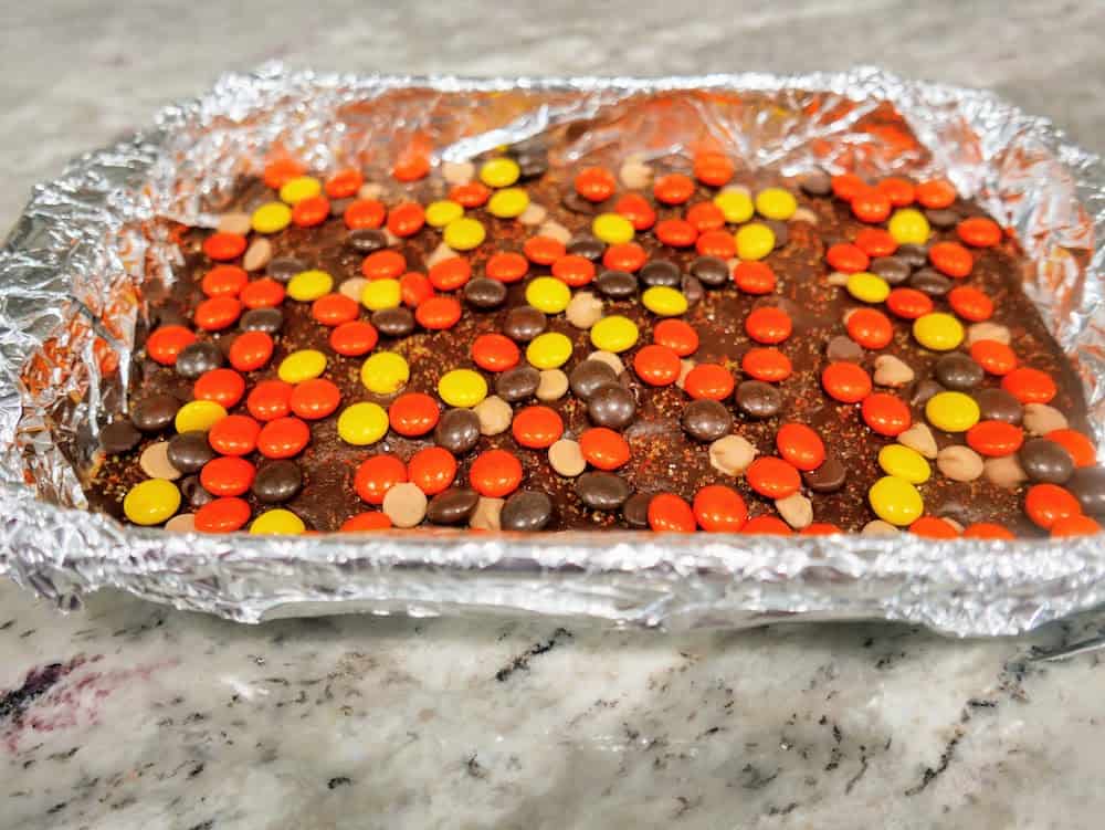 top your peanut butter fudge bars with sprinkles and Reese's Pieces