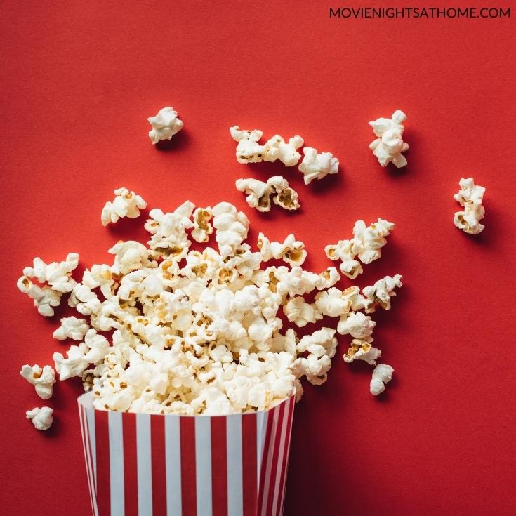 popcorn in a bucket in front of a red background