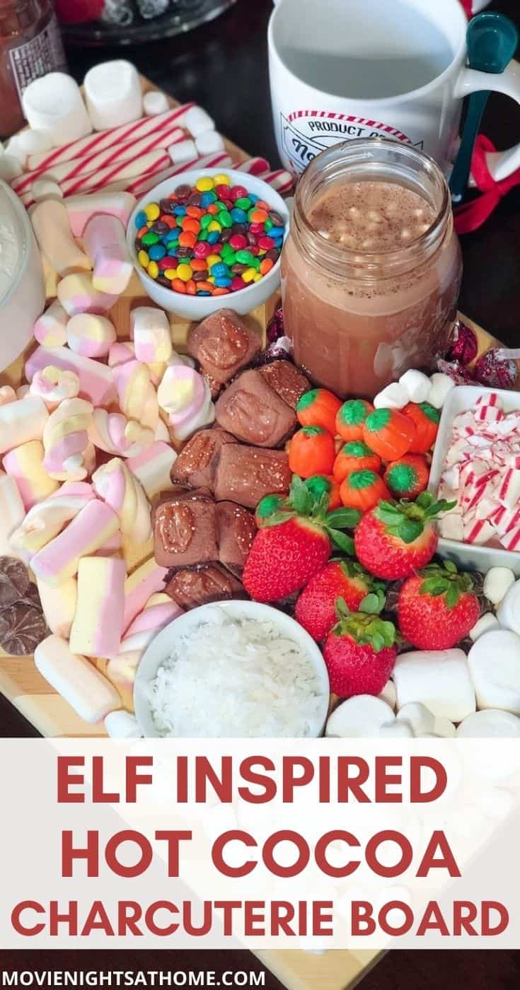 ELF hot cocoa charcuterie board with marshmallows, candy corn, candy canes, strawberries, and coconut