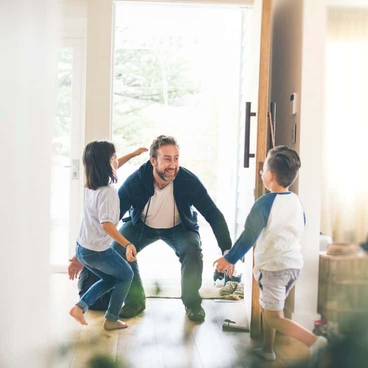 father greeting his 2 kids