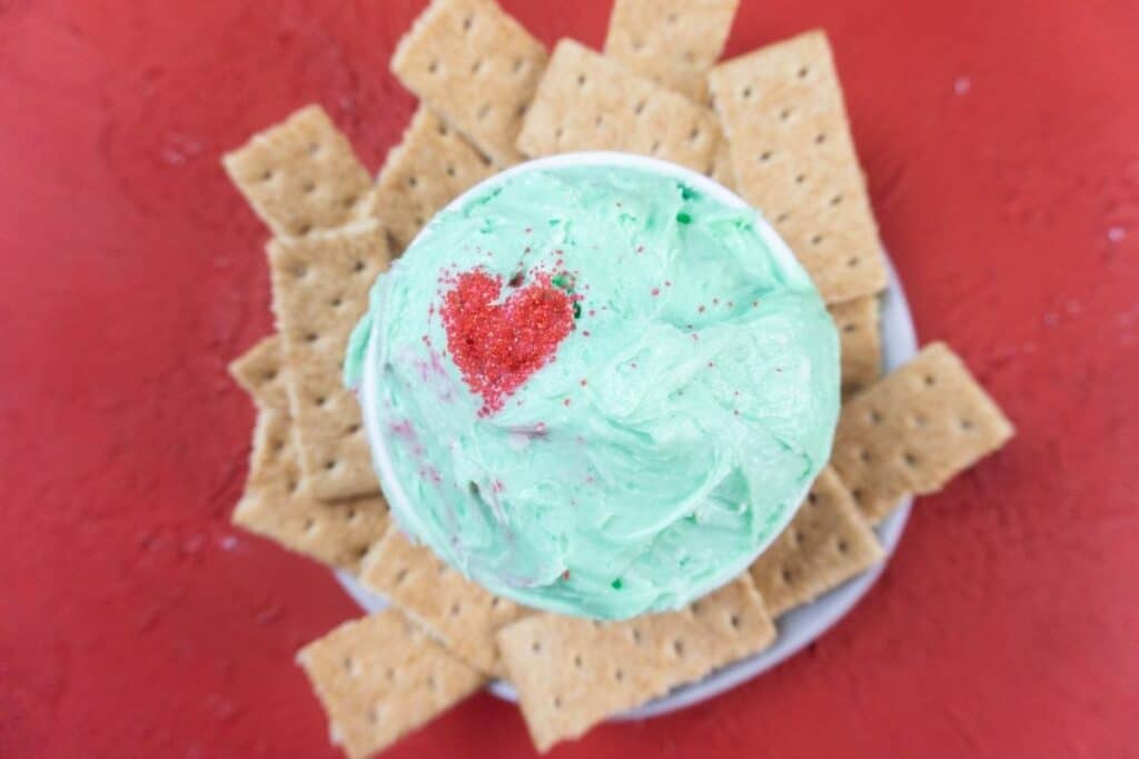 Grinch dip with graham crackers around it