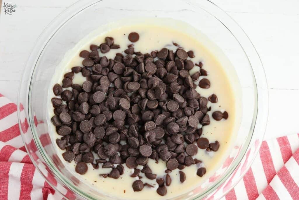 making fudge with sweetened condense milk and chocolate chips in a bowl
