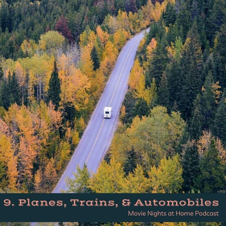 aerial pic of car traveling down road with autumn trees on each side