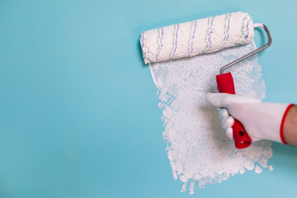 white paint going onto a blue wall