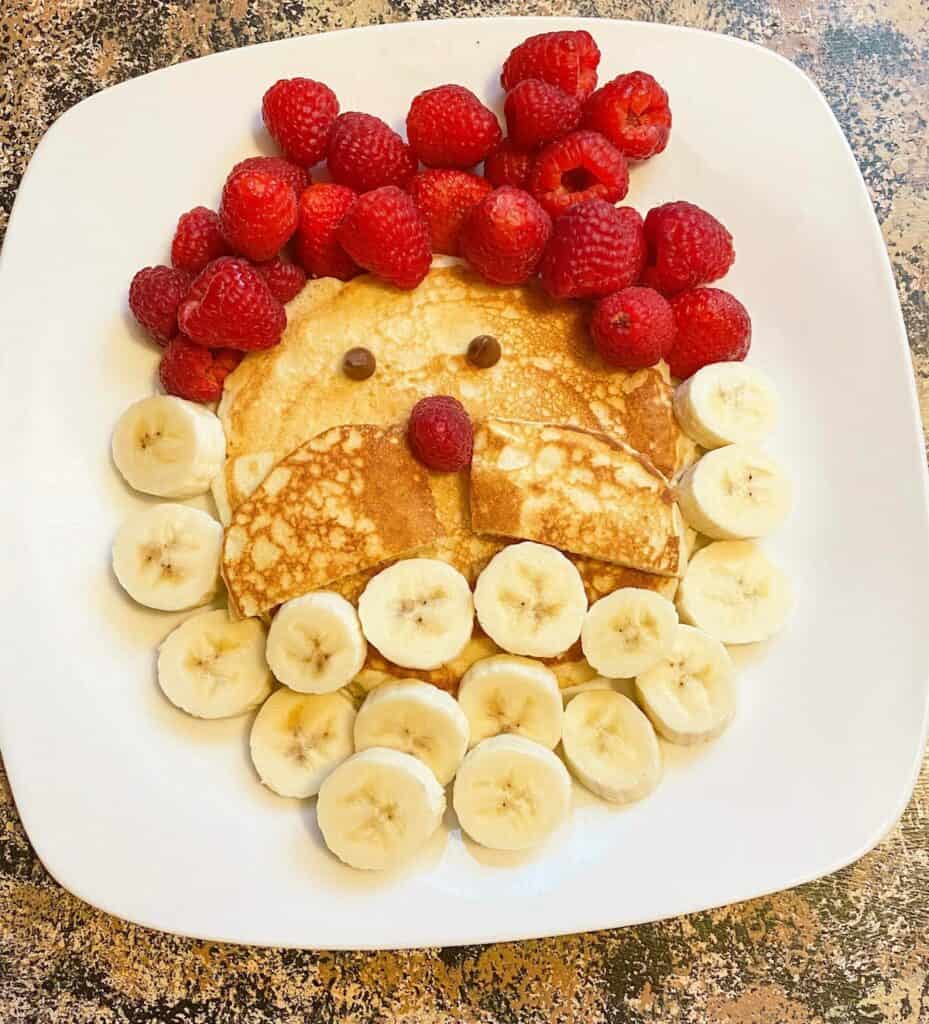 Easy Santa Pancakes for Christmas breakfast with raspberries and bananas