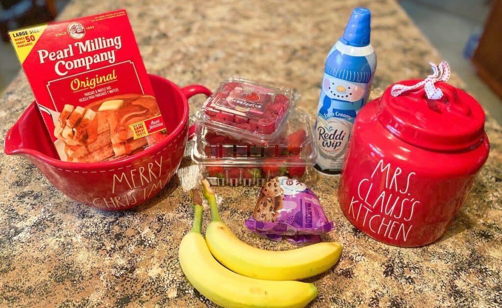 Ingredients for Santa Pancakes - bananas, pancake mix, raspberries or strawberries, and whipped cream