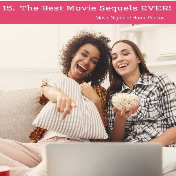 two girls watching a movie on a computer eating popcorn