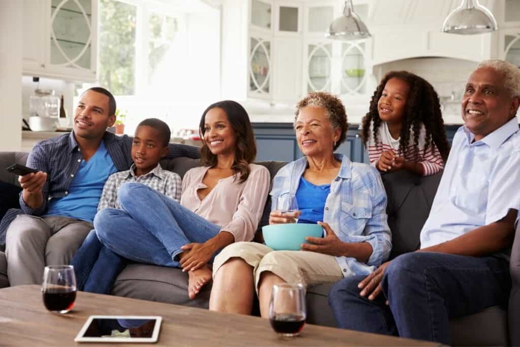 african american family watching a movie together