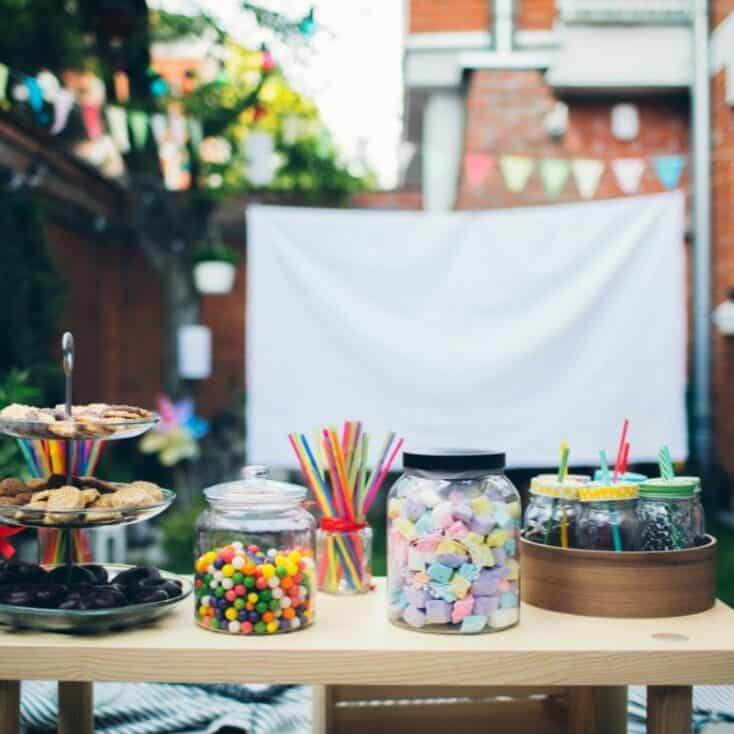 candy jars and a big screen set up for a kids movie night