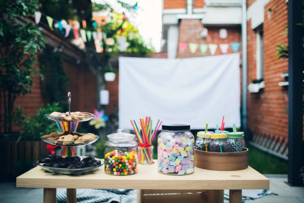 candy jars and a big screen set up for a kids movie night