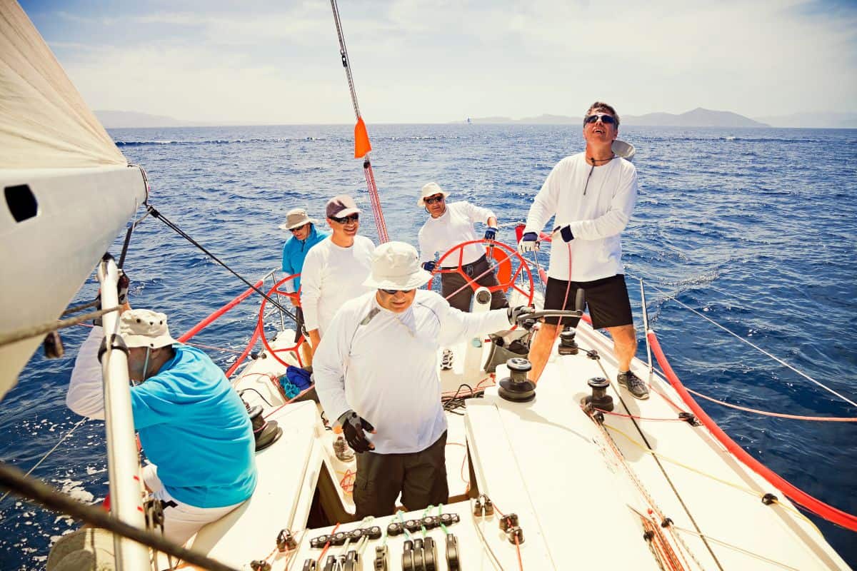 group of men working on a sailboat