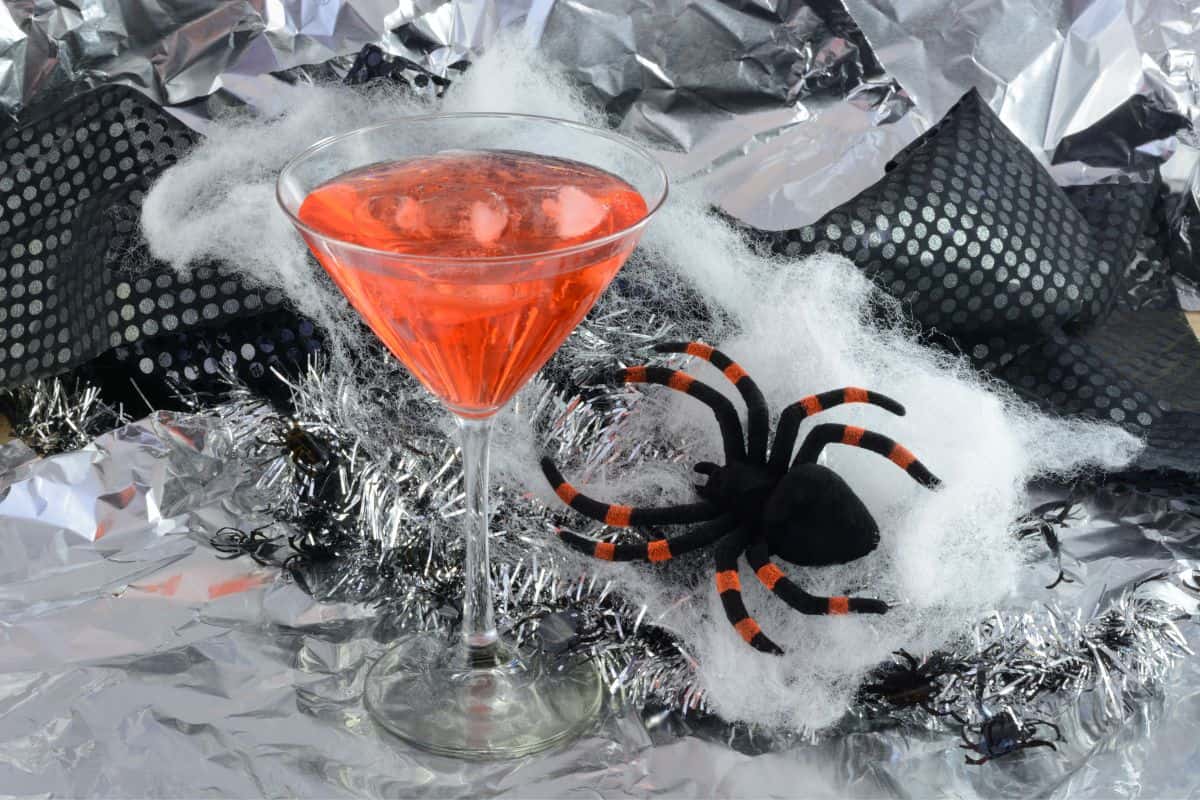 spooky red martini beside a fake spider