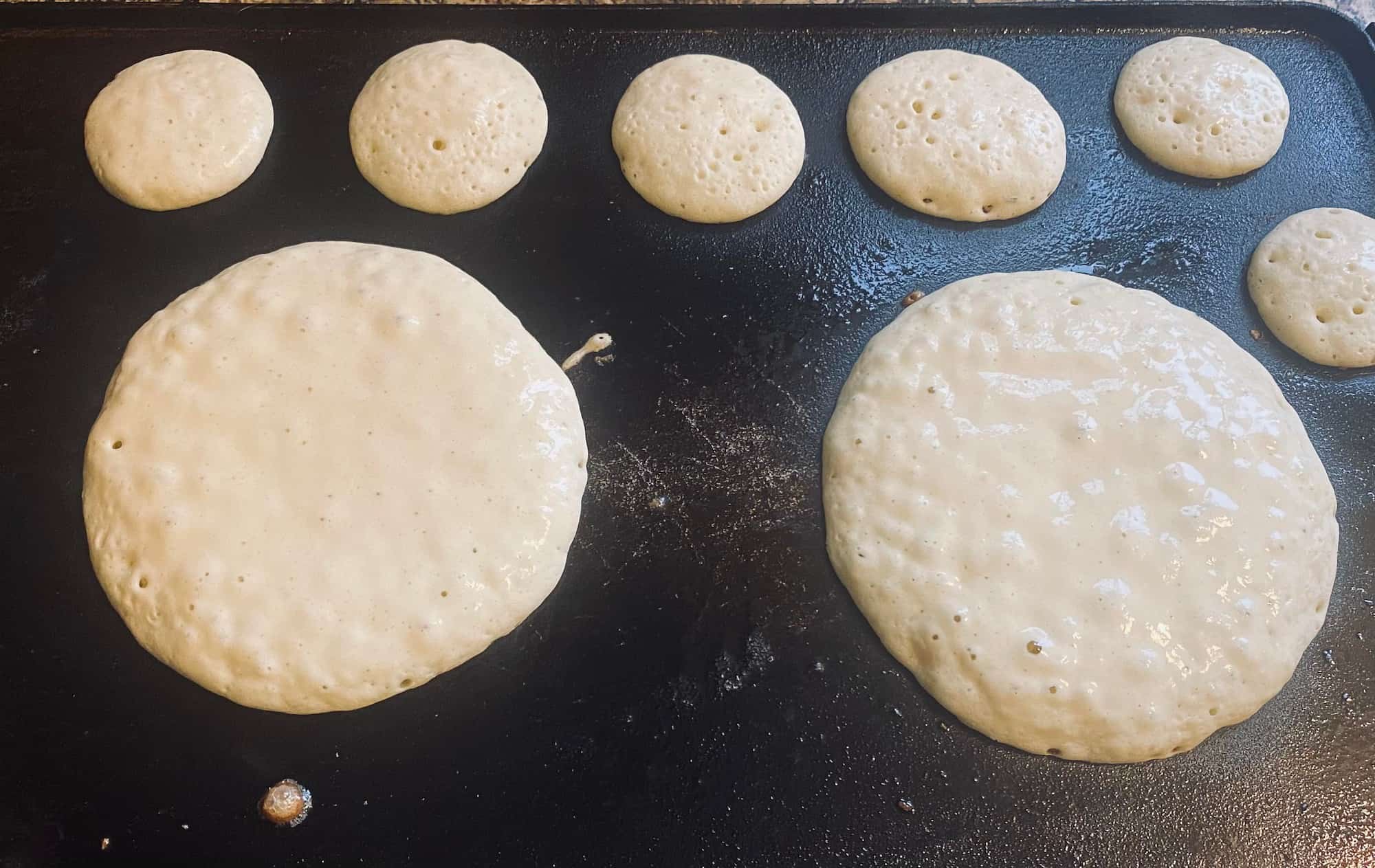 teddy bear pancake pieces on a griddle