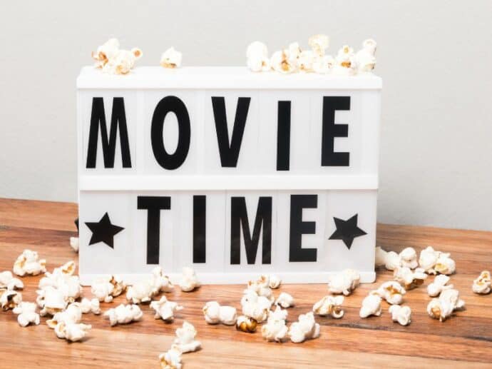 light up movie night sign with popcorn around it