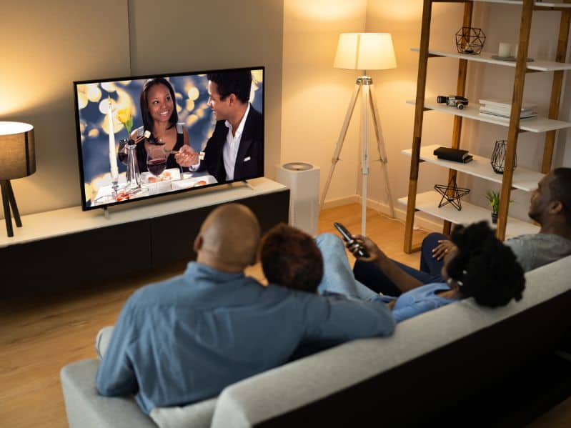 family watching a movie together on the couch