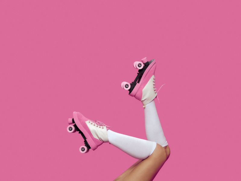 pink roller skates on someones feet